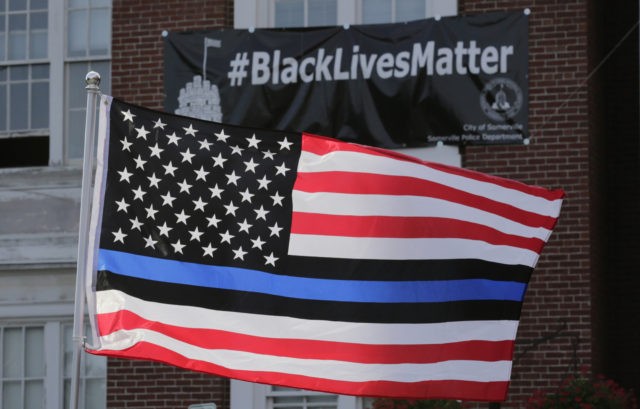 FILE - In this July 28, 2016, file photo, a flag with a blue and black stripes in support