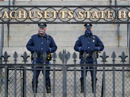 Massachusetts state troopers guard the front of the Statehouse, Wednesday, Jan. 20, 2021, in Boston. Normally quiet streets around U.S. state capitol buildings have looked more like battlegrounds recently, putting those who live and work there on edge and instilling a sense of foreboding. (AP Photo/Elise Amendola)