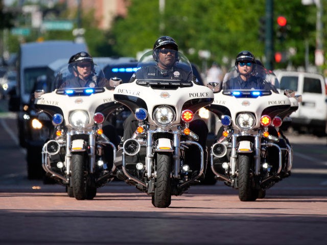 Denver Police Department motorcycle officers escort an armored vehicle carrying the most-s