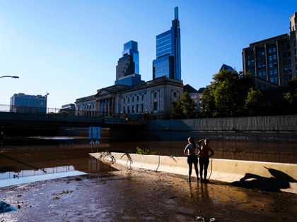 People standing on an onramp view a flooded section of Interstate 676 in Philadelphia Friday, Sept. 3, 2021 in the aftermath of downpours and high winds from the remnants of Hurricane Ida that hit the area. The cleanup and mourning has continued as the Northeast U.S. recovers from record-breaking rainfall …