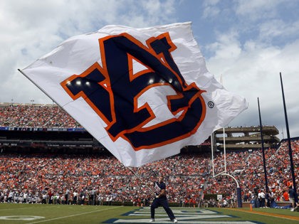 Auburn cheerleader waves a flag after a score against Alabama State during the second half of an NCAA football game Saturday, Sept. 11, 2021, in Auburn, Ala. (AP Photo/Butch Dill)