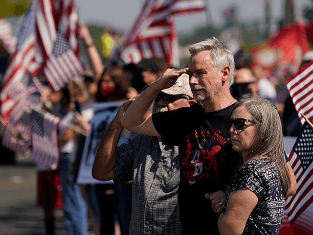 Salutes are given as the hearse carrying the remains of Marine Corps. Sgt. Nicole L. Gee, who died in a bombing at Afghanistan's Kabul airport, passes people honoring her along the route to the Mount Vernon Memorial Park in Fair Oaks, Calif., Thursday, Sept. 16, 2021. (AP Photo/Rich Pedroncelli)