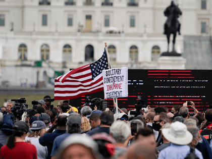 People attend a rally near the U.S. Capitol in Washington, Saturday, Sept. 18, 2021. The r