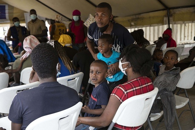 Haitians who were deported from the United States wait ti be registered after arriving at the Toussaint Louverture International Airport, in Port au Prince, Haiti, Sunday, Sep. 19, 2021. Thousands of Haitian migrants have been arriving to Del Rio, Texas, to ask for asylum in the U.S., as authorities begin to deported them to back to Haiti. (AP Photo/Rodrigo Abd)