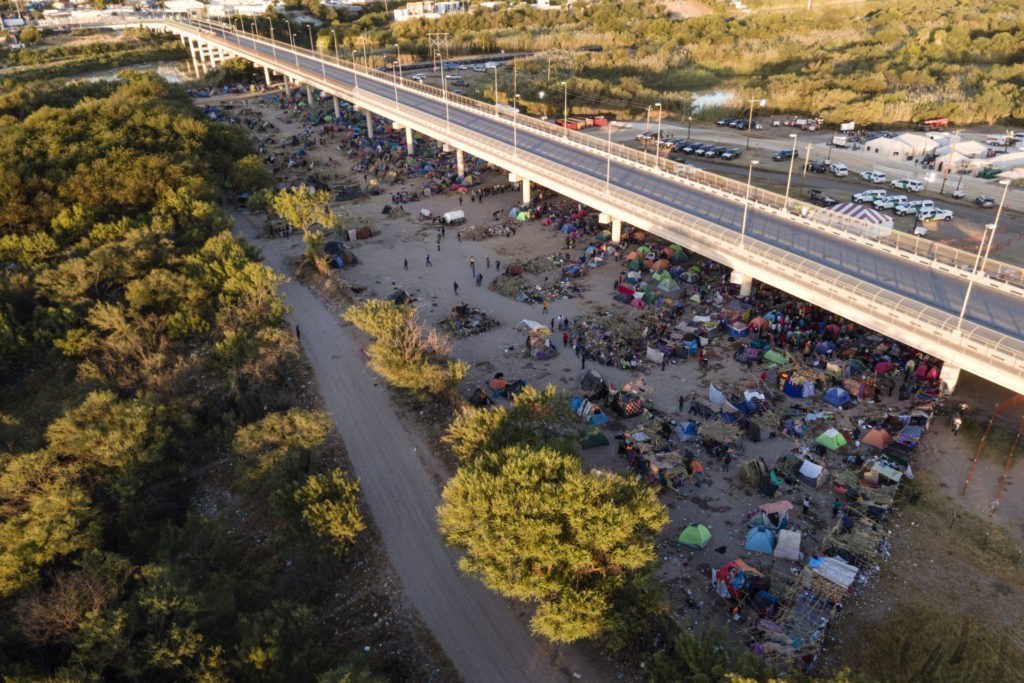 Migrants, many from Haiti, are seen in an encampment along the Del Rio International Bridge near the Rio Grande, Thursday, Sept. 23, 2021, in Del Rio, Texas. (AP Photo/Julio Cortez)