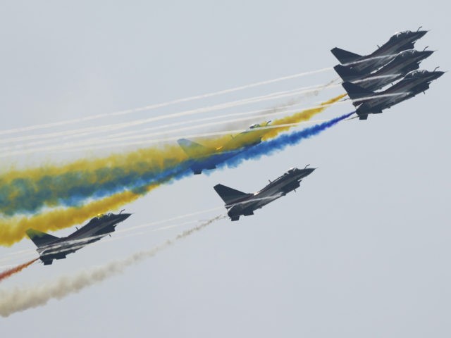 Members of the "August 1st" Aerobatic Team of the Chinese People's Liberation Army (PLA) Air Force perform during the 13th China International Aviation and Aerospace Exhibition on Wednesday, Sept. 29, 2021, in Zhuhai in southern China's Guangdong province. (AP Photo/Ng Han Guan)
