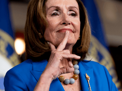 House Speaker Nancy Pelosi of Calif. reacts as she listens to a question from a reporter d