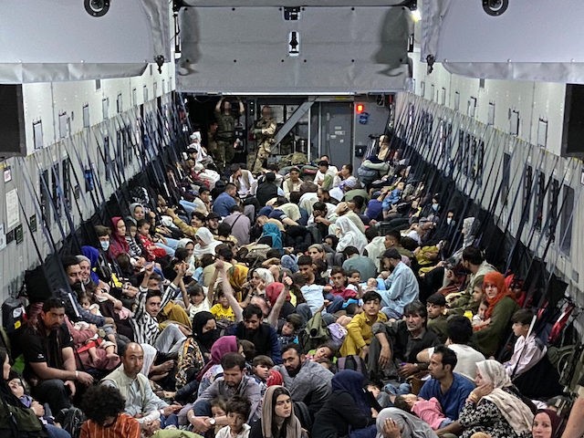 TASHKENT, UZBEKISTAN - AUGUST 22: In this handout image provided by the Bundeswehr, evacuees from Kabul sit inside a military aircraft as they arrive at Tashkent Airport on August 22, 2021 in Tashkent, Uzbekistan. German Chancellor Merkel said Germany must urgently evacuate up to 10,000 people from Afghanistan for which …