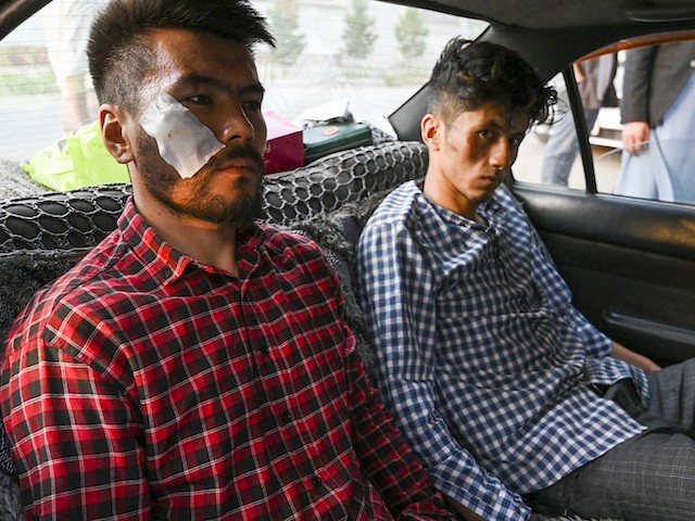 In this picture taken on September 8, 2021, Afghan newspaper Etilaat Roz journalists Nematullah  Naqdi (L) and Taqi Daryabi arrive at their office after being released from Taliban custody in Kabul (Wakil Kohsar/AFP via Getty Images)