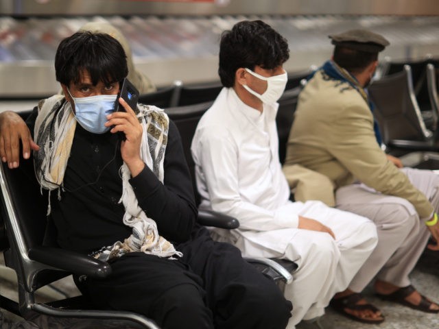 Refugees wait for transportation at Dulles International Airport after being evacuated from Kabul following the Taliban takeover of Afghanistan August 27, 2021 in Dulles, Virginia. (Chip Somodevilla/Getty Images)