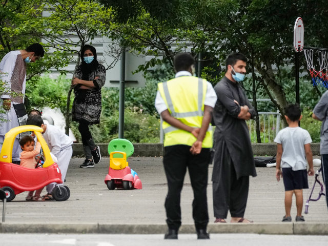 MANCHESTER, ENGLAND - AUGUST 25: People believed to have recently arrived from Afghanistan stand in the courtyard of a hotel near Manchester Airport on August 25, 2021 in Manchester, England. The British government recently announced that it planned to transport thousands of Afghans to the UK as part of its …