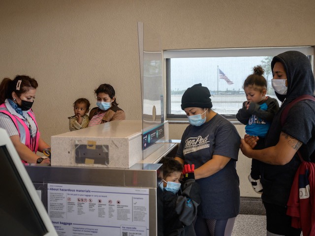 Ivania (29, C) from Honduras checks-in for a flight with her family but without her 11-year-old son Jhowell, after being released from a Border Patrol holding center for illegal immigrants, at McAllen airport, Texas, on March 30, 2021. Jhowell first arrived to the US with his parents and two siblings aged 4 and 1, but the family was deported immediately to Mexico. They decided to try again, but to be successful they had to separate: the parents and small children crossed the Rio Grande border river first, and were allowed to enter because the children were less than seven years old. Jhowell had to travel alone. (Ed Jones/AFP via Getty Images)