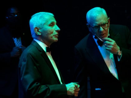 National Institute of Allergy and Infectious Diseases Director Anthony Fauci (L) speaks wi