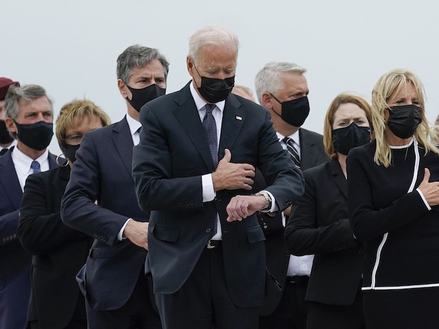 President Joe Biden, first lady Jill Biden and others attend a casualty return as a carry team finishes placing a transfer case containing the remains of Marine Corps Lance Cpl. Jared M. Schmitz, 20, of St. Charles, Mo., into the transfer vehicle Sunday, Aug. 29, 2021, at Dover Air Force Base, Del. According to the Department of Defense, Schmitz a died in an attack at Afghanistan's Kabul airport, along with 12 other U.S. service members. (AP Photo/Carolyn Kaster)