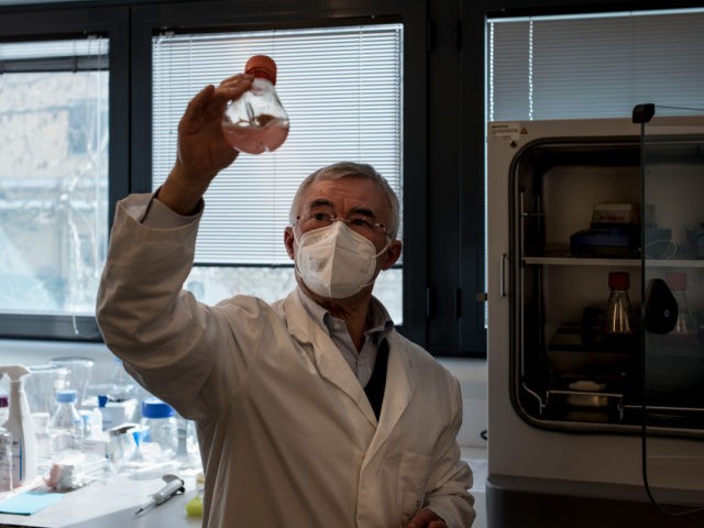 SIENA, ITALY - FEBRUARY 22: Scientific coordinator Professor Rino Rappuoli takes out a fla