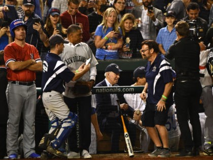 US President Joe Biden (C) sits with members of the Democrats baseball team during the Congressional Baseball Game for charity at Nationals Park in Washington, DC on September 29, 2021. - Biden was inducted into the Congressional Baseball Hall of Fame earlier this evening. (Photo by Brendan Smialowski / AFP) …