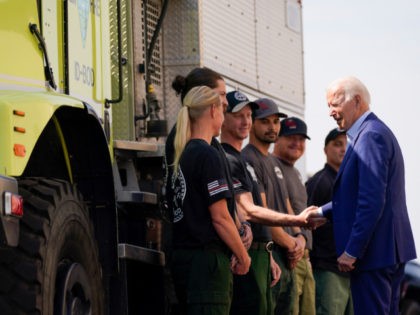 President Joe Biden greets firefighters as he tours the National Interagency Fire Center, Monday, Sept. 13, 2021, in Boise, Idaho. (AP Photo/Evan Vucci)