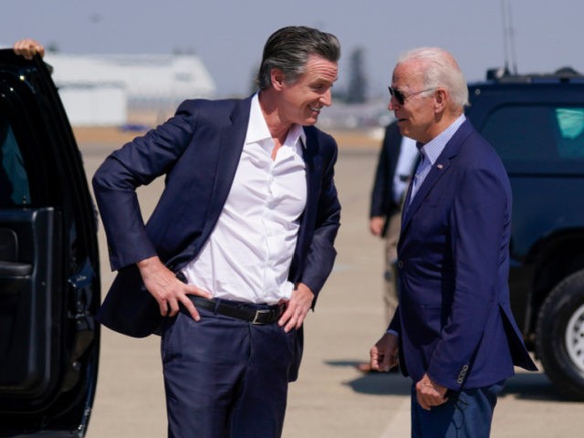 President Joe Biden talks with California Gov. Gavin Newsom as he arrives at Mather Airport on Air Force One Monday, Sept. 13, 2021, in Mather, Calif., for a briefing on wildfires at the California Governor's Office of Emergency Services. (AP Photo/Evan Vucci)