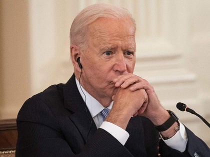 US President Joe Biden listens as India Prime Minister Narendra Modi speaks with Japan Prime Minister Suga Yoshihide and Australian Primer Minister Scott Morrison during the first-ever in-person Quad Leaders Summit in the East Room of the White House in Washington, DC, on September 24, 2021. (Photo by Jim WATSON …