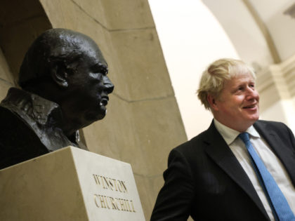 WASHINGTON, DC - SEPTEMBER 22: British Prime Minister Boris Johnson stands next to a bust