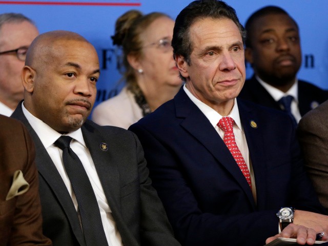 Speaker of the New York State Assembly Carl Heastie, left, and New York Gov. Andrew Cuomo listen to speakers at the National Action Network House of Justice, in New York, Monday, Jan. 15, 2018. Prominent lawmakers and community leaders took aim at President Donald Trump's racial rhetoric at a New York commemoration of Martin Luther King Jr.'s birthday. (AP Photo/Richard Drew)