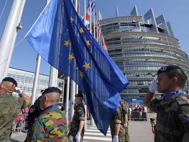 Soldiers of Eurocorps raise an European Union flag during the flag-raising ceremony on the