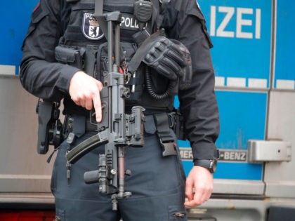 A police officer with a machine gun stands in front of the Al-Irschad Mosque during a raid on April 30, 2020 in Berlin, as dozens of police and special forces stormed mosques and associations linked to Hezbollah in Bremen, Berlin, Dortmund and Muenster in the early hours of the morning. …