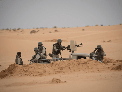 Mauritanian soldiers stand guard at a G5 Sahel task force command post, on November 22, 2018, in the southeast of Mauritania near the border with Mali. - Remote villages near the border with Mali, have long been neglected by authorities, making them easier prey for jihadists and other armed groups …