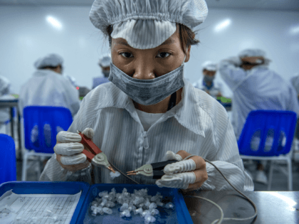 SHENZHEN, CHINA -SEPTEMBER 24: A worker tests parts for e-cigarettes on the production line at Kanger Tech, one of China's leading manufacturers of vaping products, on September 24, 2019 in Shenzhen, China. Global production for e-cigarette and vaping products is centered in a five-square-mile district of Shenzhen, China, which is …