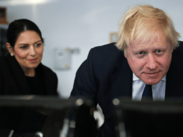 Britain's Prime Minister Boris Johnson (R) and Home Secretary Priti Patel visit a security control room at the docks in Southampton, southeast England on December 2, 2019. (Photo by HANNAH MCKAY / POOL / AFP) (Photo by HANNAH MCKAY/POOL/AFP via Getty Images)