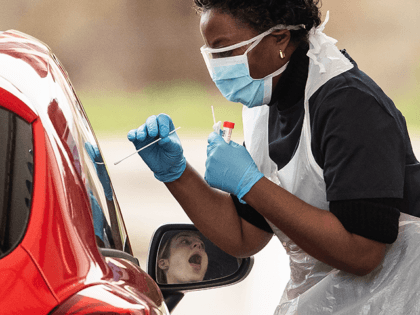 A nurse takes a swab at a Covid-19 Drive-Through testing station for NHS staff on March 30, 2020 in Chessington, United Kingdom. The Coronavirus (COVID-19) pandemic has spread to many countries across the world, claiming over 30,000 lives and infecting hundreds of thousands more. (Photo by Dan Kitwood/Getty Images)