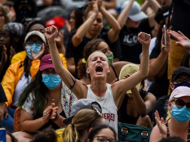 Demonstrators clap and yell as they gather on June 2, 2020 in Saint Paul, Minnesota, to protest the death of George Floyd while in police custody. - Thousands of National Guard troops patrolled major US cities after protests over racism and police brutality boiled over into arson and looting, sending …
