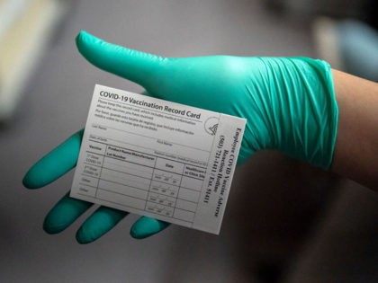 PORTLAND, OR - DECEMBER 16: A healthcare worker displays a COVID-19 vaccine record card at the Portland Veterans Affairs Medical Center on December 16, 2020 in Portland, Oregon. The first rounds of Pfizer's vaccine were administered in Oregon on Wednesday. (Photo by Nathan Howard/Getty Images)