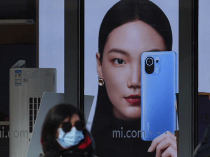 People walk past a Xiaomi store in Beijing on January 15, 2021, as shares in the company c