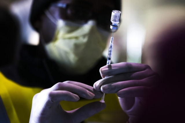 DENVER, CO - JANUARY 30: Pharmacy technicians prepare doses of the Pfizer-BioNTech vaccine