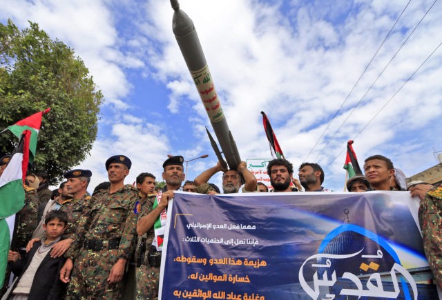 Supporters of Yemen's Shiite Huthi movement lift anti-Israel placards, a mock missile, and Palestinians flags during a rally in the capital Sanaa, on May 7, 2021, marking the yearly al-Quds (Jerusalem) day which falls on the last Friday of the holy month of Ramadan. (Photo by Mohammed HUWAIS / AFP) …