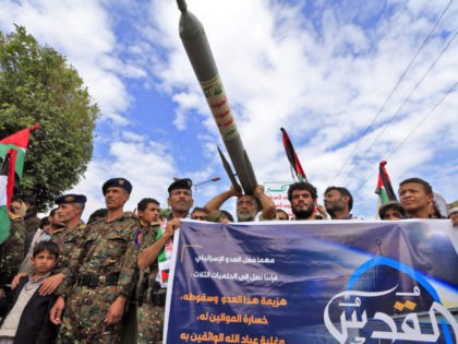 Supporters of Yemen's Shiite Huthi movement lift anti-Israel placards, a mock missile, and Palestinians flags during a rally in the capital Sanaa, on May 7, 2021, marking the yearly al-Quds (Jerusalem) day which falls on the last Friday of the holy month of Ramadan. (Photo by Mohammed HUWAIS / AFP) …