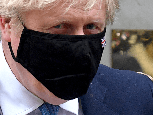 Britain's Prime Minister Boris Johnson, wearing a face mask to combat the spread of the no