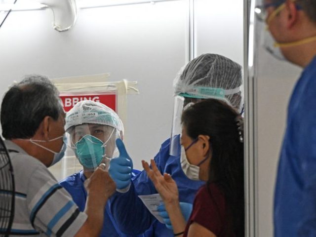 Residents are tested at a temporary swab centre set up at the void deck area on the ground