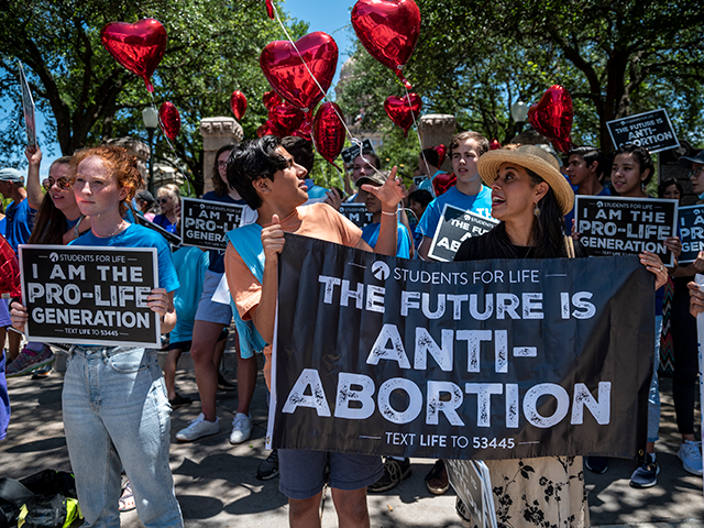 Pro-life protesters stand near the gate of the Texas state capitol at a protest outside the Texas state capitol on May 29, 2021 in Austin, Texas. Thousands of protesters came out in response to a new bill outlawing abortions after a fetal heartbeat is detected signed on Wednesday by Texas Governor Greg Abbot. (Photo by Sergio Flores/Getty Images)