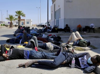 African migrants who were rescued by the Tunisian army as they attempted to cross the Mediterranean Sea by boat, rest at the port of El Ketef in Ben Guerdane, in southern Tunisia near the border with Libya, on June 11, 2021. - Tunisia and Libya are key departure points for …