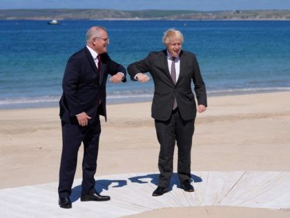 Britain's Prime Minister Boris Johnson (R) greets Australia's Prime Minister Scott Morrison (L) during an official welcome during the G7 summit in Carbis Bay, Cornwall on June 12, 2021. - G7 leaders from Canada, France, Germany, Italy, Japan, the UK and the United States meet this weekend for the first …