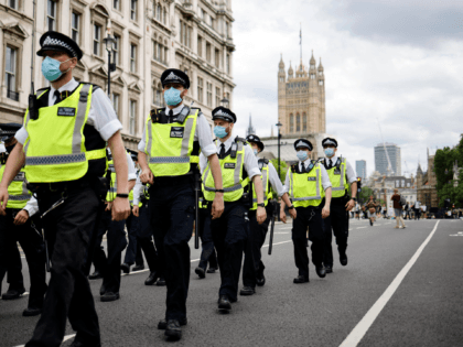 Police officers patrol the streets of Westminster as protesters gather for a demonstration
