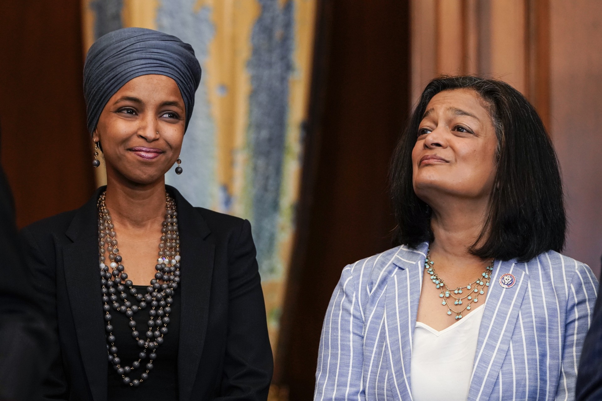 WASHINGTON, DC - JUNE 17: Reps. Ilhan Omar (D-MI) and Pramila Jayapal (D-WA) listen as Speaker of the House Nancy Pelosi (D-CA) holds a bill enrollment signing ceremony for the Juneteenth National Independence Day Act on June 17, 2021 on Capitol Hill in Washington, DC. Juneteenth, celebrated on June 19th, commemorates the of the end of slavery in the United States and will be celebrated as a national holiday. (Photo by Joshua Roberts/Getty Images)