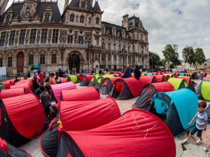 Homeless migrants stand next to tents installed a day before during an action organised by French association Utopia56 in front of the City Hall in Paris, on June 25, 2021, to highlight the plight of the homeless in central Paris. (Photo by JOEL SAGET / AFP) (Photo by JOEL SAGET/AFP …