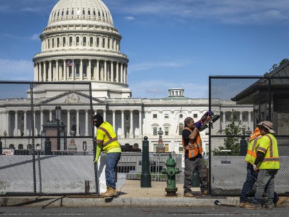 WASHINGTON, DC - JULY 10: Workers remove security fencing surrounding the U.S. Capitol on July 10, 2021 in Washington, DC. The security fence was erected in the wake of the January 6 attack on the Capitol and will be mostly removed this weekend. (Photo by Drew Angerer/Getty Images)
