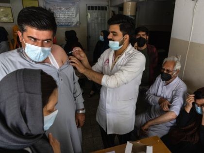 KABUL, AFGHANISTAN - JULY 14: Doctor Roheed Mureed (right) vaccinates Afghans with the J&a