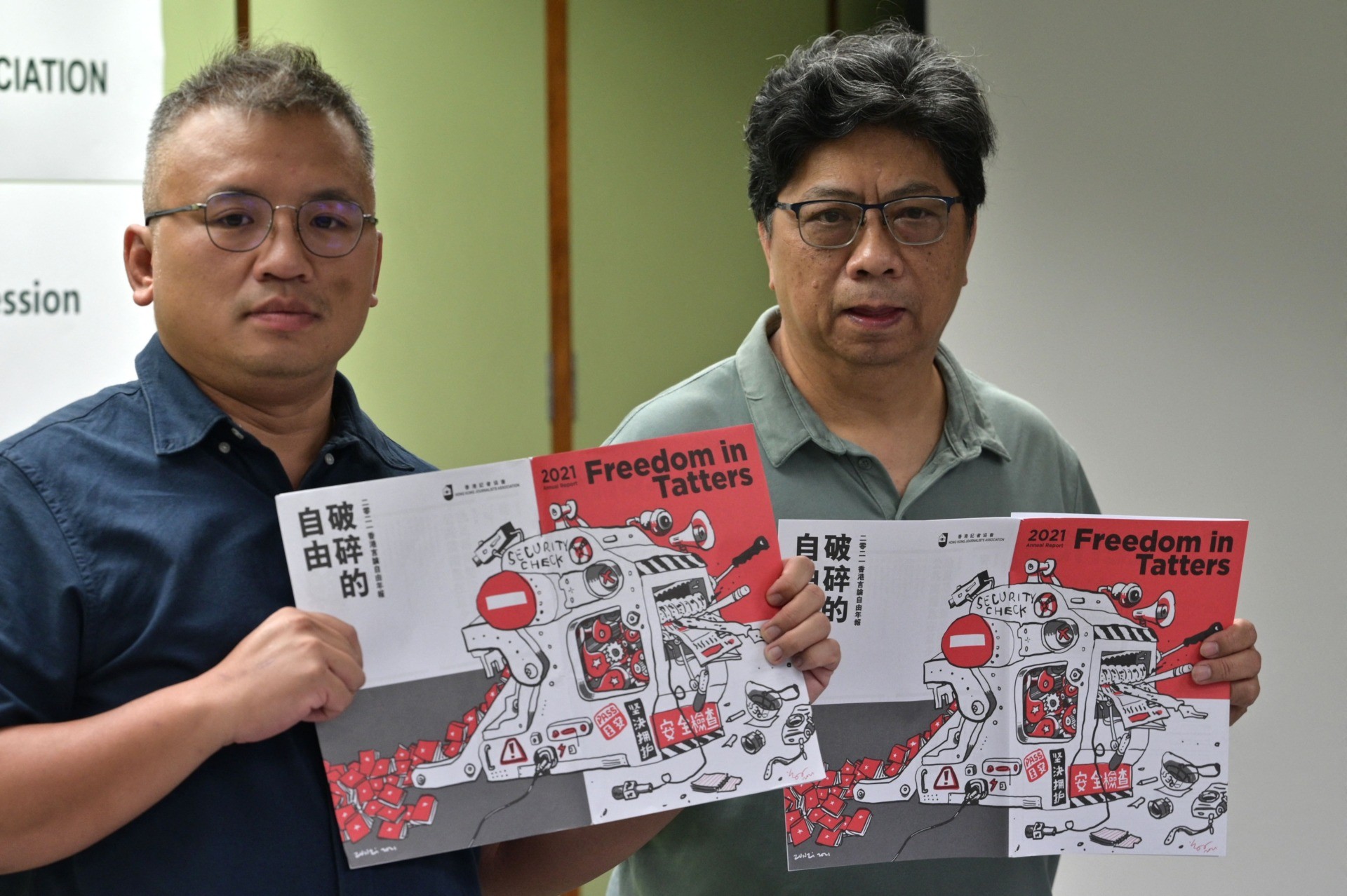 Chairperson of the Hong Kong Journalists Association (HKJA) Ronson Chan (L) and Chris Yeung, chief editor of the annual report, pose during a press conference for the release of the organisations annual report Freedom in Tatters in Hong Kong on July 15, 2021. (Photo by Anthony WALLACE / AFP) (Photo by ANTHONY WALLACE/AFP via Getty Images)