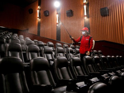 A worker sanitizes a movie theatre in Santiago on July 19, 2021, amid the COVID-19 pandemi