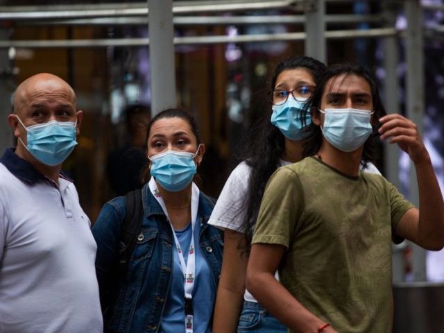 People wear a face masks in Midtown Manhattan in New York on July 29 2021. - Every US federal worker must either declare they are fully vaccinated against Covid-19 or wear masks and be regularly tested, President Joe Biden was to announce July 29, 2021, the White House said, as …